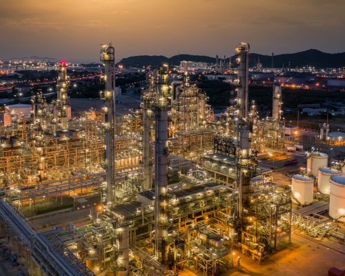 Oil refinery plant from industry zone, Aerial view oil and gas petrochemical industrial, Refinery factory oil storage tank and pipeline steel at night, Oil and gas refinery plant at night industrial petrochemical fuel power and energy.